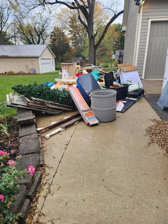 Dumpster being loaded with debris for 12 Yard Dumpster Rental in Rock Falls